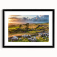 Framed wall art showcasing a serene countryside landscape with rolling hills and lush greenery, featuring a sleek black frame and white matting for an elegant display. This piece captures the tranquility of nature, perfect for enhancing home decor.
