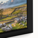 Close-up of a framed landscape wall art piece showcasing a serene countryside scene with vibrant greens and soft blues, perfect for home decor enhancement.