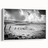 Framed wall art showcasing a serene countryside landscape with vibrant greens and subtle blues, presented in a sleek white frame, ideal for home decor.