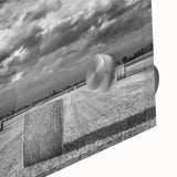 Close-up of an acrylic glass wall art piece showcasing a serene countryside landscape, featuring vibrant greens and soft blues that evoke tranquility, perfect for home decor.