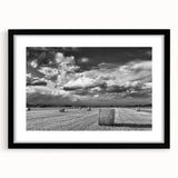 Framed wall art depicting a serene countryside landscape in vibrant colors, featuring a black mat and frame, ideal for home decor and enhancing interior spaces.