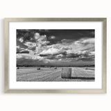 Framed wall art showcasing a serene countryside landscape design, featuring lush greenery and rolling hills, set in an elegant silver frame with a mat for enhanced display.