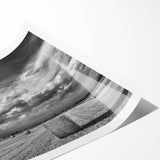 Vibrant countryside landscape wall art print depicting rolling hills and a serene sky, rolled and securely packaged in a protective cardboard tube for shipping.