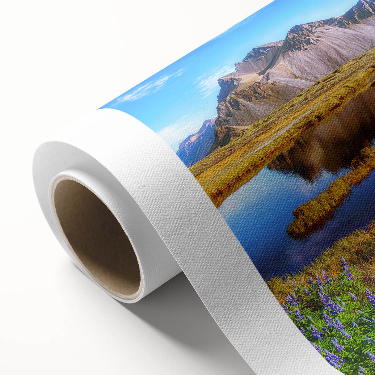 Rolled canvas artwork showcasing a serene countryside landscape with vibrant green fields and a clear blue sky, perfect for home decor and artistic expression.