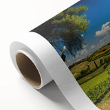 Rolled canvas showcasing a serene countryside landscape design, featuring lush green fields and a vibrant sunset, ideal for home decor and wall art collections.