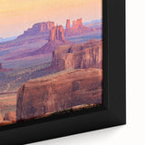 Close-up of a framed canvas artwork showcasing a vibrant desert landscape design, featuring warm hues of orange and yellow, perfect for modern home décor.