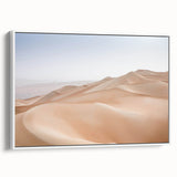 Framed canvas wall art showcasing a vibrant desert landscape design with warm hues of orange and yellow, set against a white frame, ideal for modern home decor.