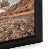 Close-up of a framed canvas featuring a vibrant desert landscape design, showcasing warm tones of orange and yellow with detailed textures, ideal for modern home decor.