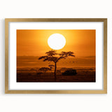 Framed wall art featuring a vibrant desert landscape design, encased in a gold frame with a mat, perfect for home decor. Ideal for adding warmth and color to any room.