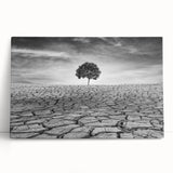 Stretched canvas wall art showcasing a vibrant desert landscape design, featuring warm hues of orange and yellow, leaning against a neutral wall, ideal for home decor.