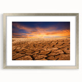 Framed wall art showcasing a stunning desert landscape design, featuring warm tones of orange and gold, complemented by a silver mat and frame, perfect for home decor.