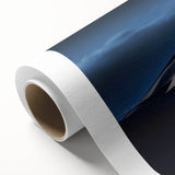 Vibrant rolled canvas artwork showcasing abstract desert dunes in warm hues of orange and gold, ideal for modern home decor, elegantly packaged in a protective tube.