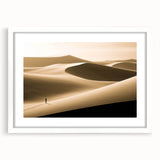 Framed wall art featuring a serene desert landscape with rolling sand dunes, designed with a white mat and sleek frame, perfect for home decor enhancement.