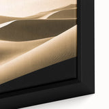 Close-up of a framed canvas wall art piece showcasing a vibrant desert dune landscape in warm tones, ideal for home decor, adding a touch of nature's beauty.