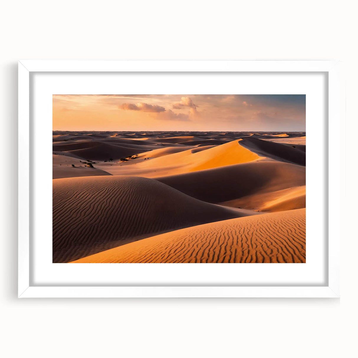Framed wall art showcasing a serene desert landscape with golden sand dunes, presented in a sleek white mat and frame, ideal for modern home decor.