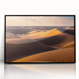 Framed acrylic wall art featuring a serene desert landscape with rolling dunes, set in a sleek black frame, ideal for modern home decor. Perfect for enhancing any living space with its calming colors and natural beauty.