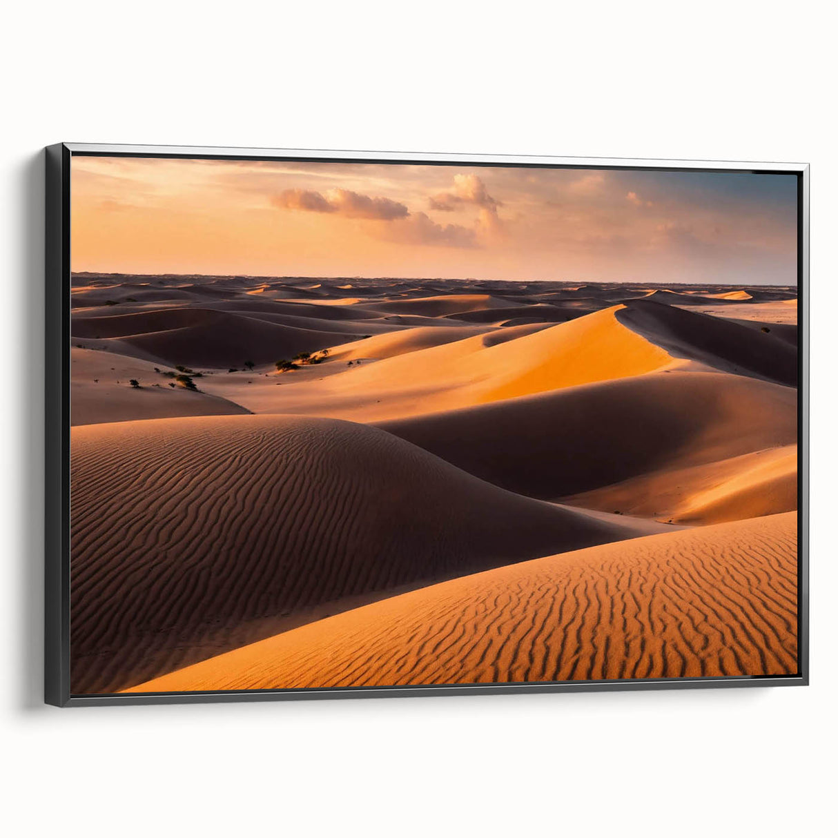 Framed canvas wall art showcasing a serene desert landscape with rolling sand dunes, presented in a sleek black frame, ideal for modern home decor.