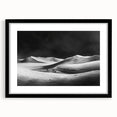 Framed wall art featuring a serene desert landscape with dunes, presented in a sleek black frame with a mat, perfect for modern home decor.