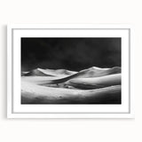 Framed wall art depicting serene sand dunes in a minimalist design, featuring a white mat and frame, perfect for modern home decor and enhancing interior spaces.