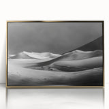 Framed wall art featuring an elegant desert dune landscape in warm gold tones, set in a sleek acrylic frame, perfect for modern home decor.