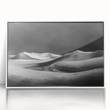 Framed acrylic wall art showcasing a serene desert dune landscape, featuring soft beige and warm orange tones, perfect for enhancing modern home decor.