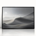 Framed wall art showcasing a serene desert dune landscape in warm earth tones, featuring a sleek black frame and acrylic front, perfect for modern decor.