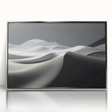 Framed wall art showcasing a serene desert landscape with golden dunes and a bright blue sky, featuring a sleek silver frame that enhances its elegance. Perfect for modern home decor.