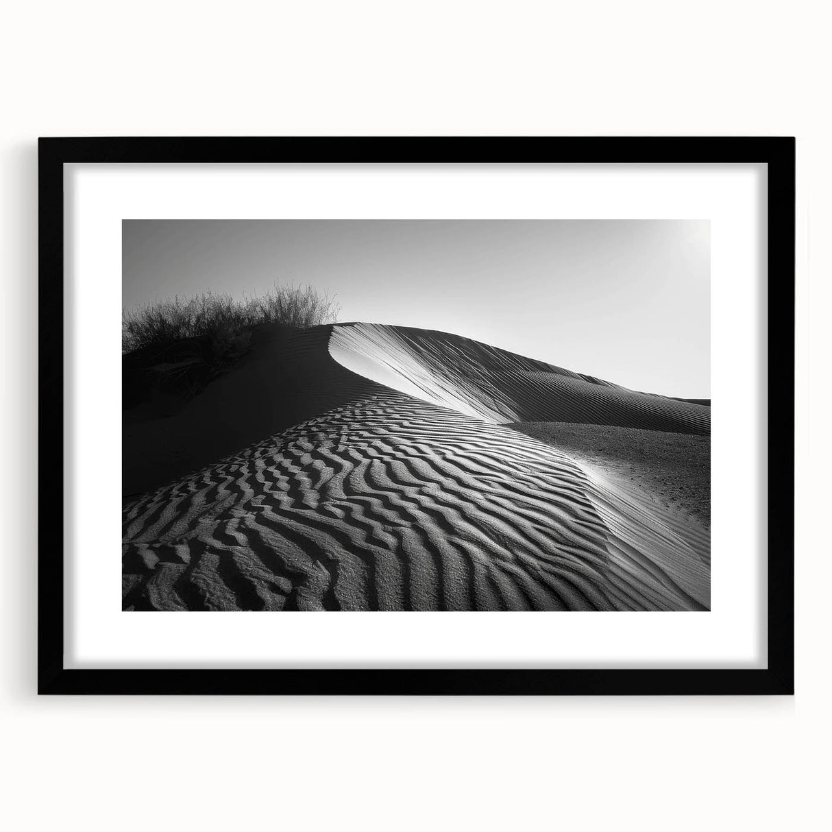 Framed wall art featuring a serene desert landscape with golden sand dunes, set in a sleek black frame with a white mat, perfect for modern home decor.
