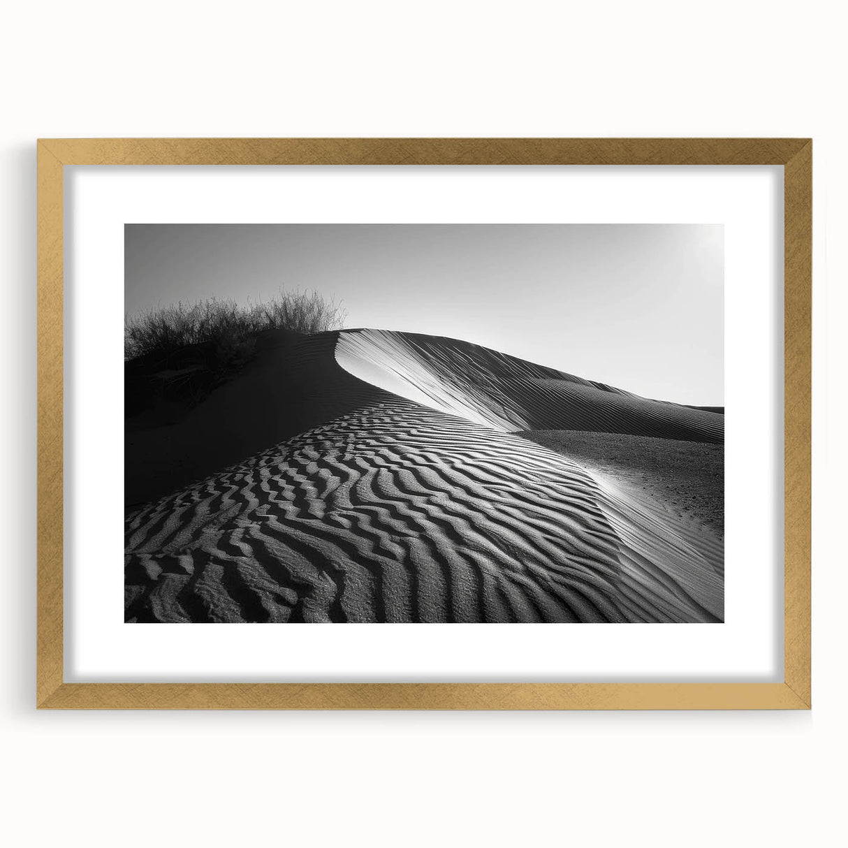 Framed wall art featuring a serene desert dune landscape with soft golden tones, elegantly matted and displayed in a sleek gold frame, perfect for modern decor.