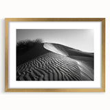 Framed wall art featuring a serene desert dune landscape with soft golden tones, elegantly matted and displayed in a sleek gold frame, perfect for modern decor.
