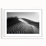 Framed wall art showcasing a serene desert landscape with rolling dunes, featuring a minimalist white mat and frame, ideal for modern home decor and interior design.
