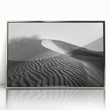 Framed acrylic wall art featuring a stunning landscape design of rolling sand dunes in warm earthy tones, elegantly displayed with a silver frame, ideal for home decor.