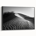 Framed wall art canvas featuring a serene desert landscape with golden dunes and a soft blue sky, showcasing a modern design with a sleek black frame, perfect for home decor.