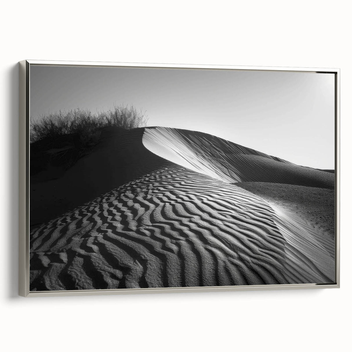 Framed canvas wall art depicting serene sand dunes under a clear sky, featuring a silver frame that enhances the modern design, perfect for home decor.