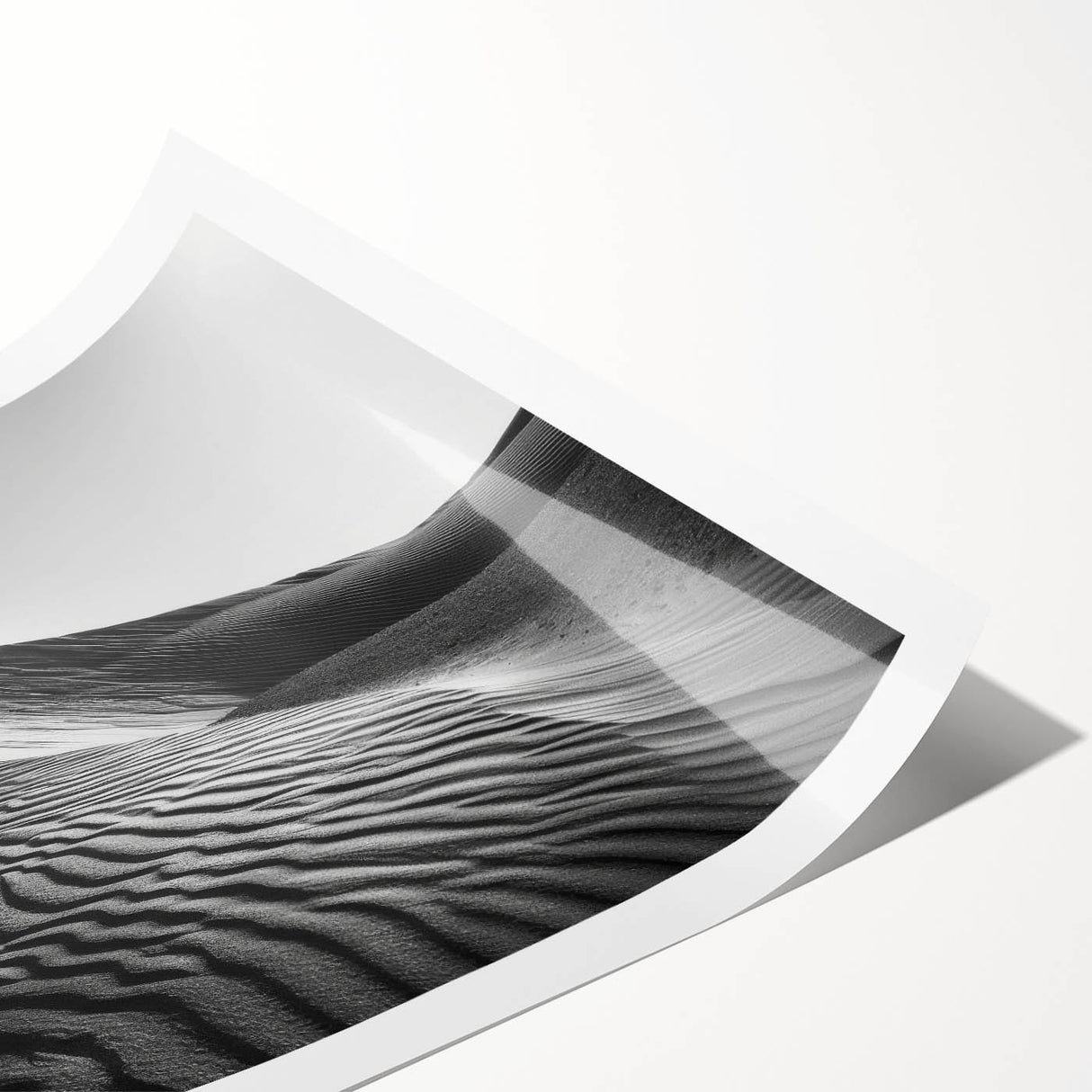 Desert landscape wall art print showcasing vibrant dunes and a serene sky, rolled and ready for display, perfect for home decor enthusiasts.