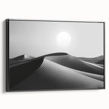 Framed canvas wall art featuring a serene desert dunes landscape design with warm beige and brown tones, displayed in a sleek black frame from the side view.