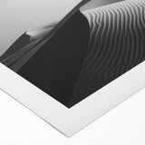 Rolled canvas artwork showcasing serene desert dunes in warm hues, ideal for modern home decor, presented in a protective cardboard tube for safe shipping.