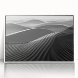 Framed acrylic wall art showcasing a serene desert landscape with rolling dunes in soft beige and subtle blue tones, ideal for modern home decor.