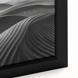 Close-up of a framed canvas wall art piece showcasing a serene desert landscape with rolling dunes, warm golden hues, and soft shadows, ideal for home decor.