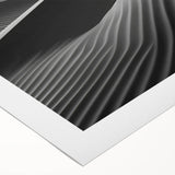 Rolled canvas showcasing an abstract landscape of sand dunes in warm tones, ideal for modern decor, packed securely in a protective tube for delivery.