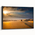 Framed canvas artwork showcasing a serene desert landscape with golden dunes and a blue sky, presented in a sleek black frame, ideal for modern home decor.