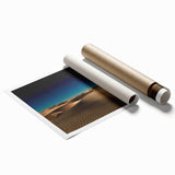 Desert landscape wall art print showcasing golden sand dunes under a vibrant blue sky, rolled and ready for framing, perfect for enhancing modern decor.