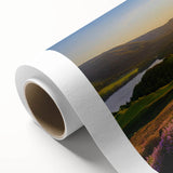Vibrant rolled canvas artwork showcasing a serene landscape with rolling fields and a colorful sunset, ideal for home décor enthusiasts seeking nature-inspired wall art.