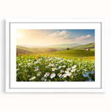 Framed wall art featuring a serene landscape of lush green fields under a bright blue sky, with a white mat for a polished finish, ideal for home décor.