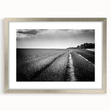 Silver-framed wall art featuring a serene landscape design with fields, presented with a mat for added elegance, perfect for home decor.