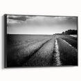 Framed canvas wall art showcasing a vibrant landscape design with lush green fields and a dramatic sky, presented in a sleek black frame, enhancing modern home decor.