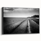 Framed canvas wall art showcasing a vibrant landscape design with lush green fields and a dramatic sky, presented in a sleek black frame, enhancing modern home decor.