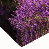 Close-up of a vibrant stretched canvas featuring a serene landscape design with lush green fields and a bright blue sky, perfect for home decor.