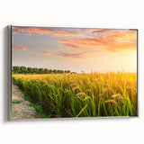 Framed canvas wall art featuring a serene landscape of vast, green fields under a bright blue sky, accented with a sleek silver frame, ideal for home decor.