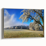 Framed canvas wall art showcasing a serene landscape of rolling fields under a clear blue sky, with a sleek silver frame enhancing its modern design. Perfect for home decor.